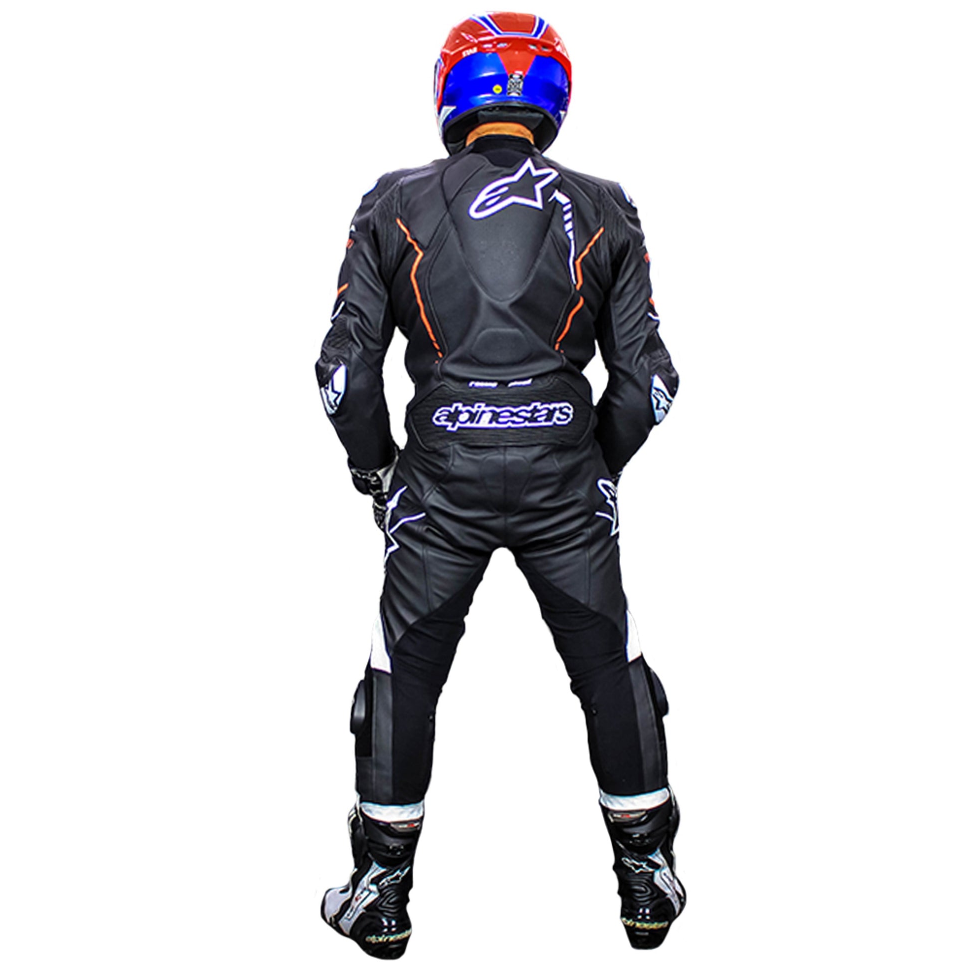 Rear view of a black alpinestars racing suit worn by a motorcyclist with a red and blue helmet